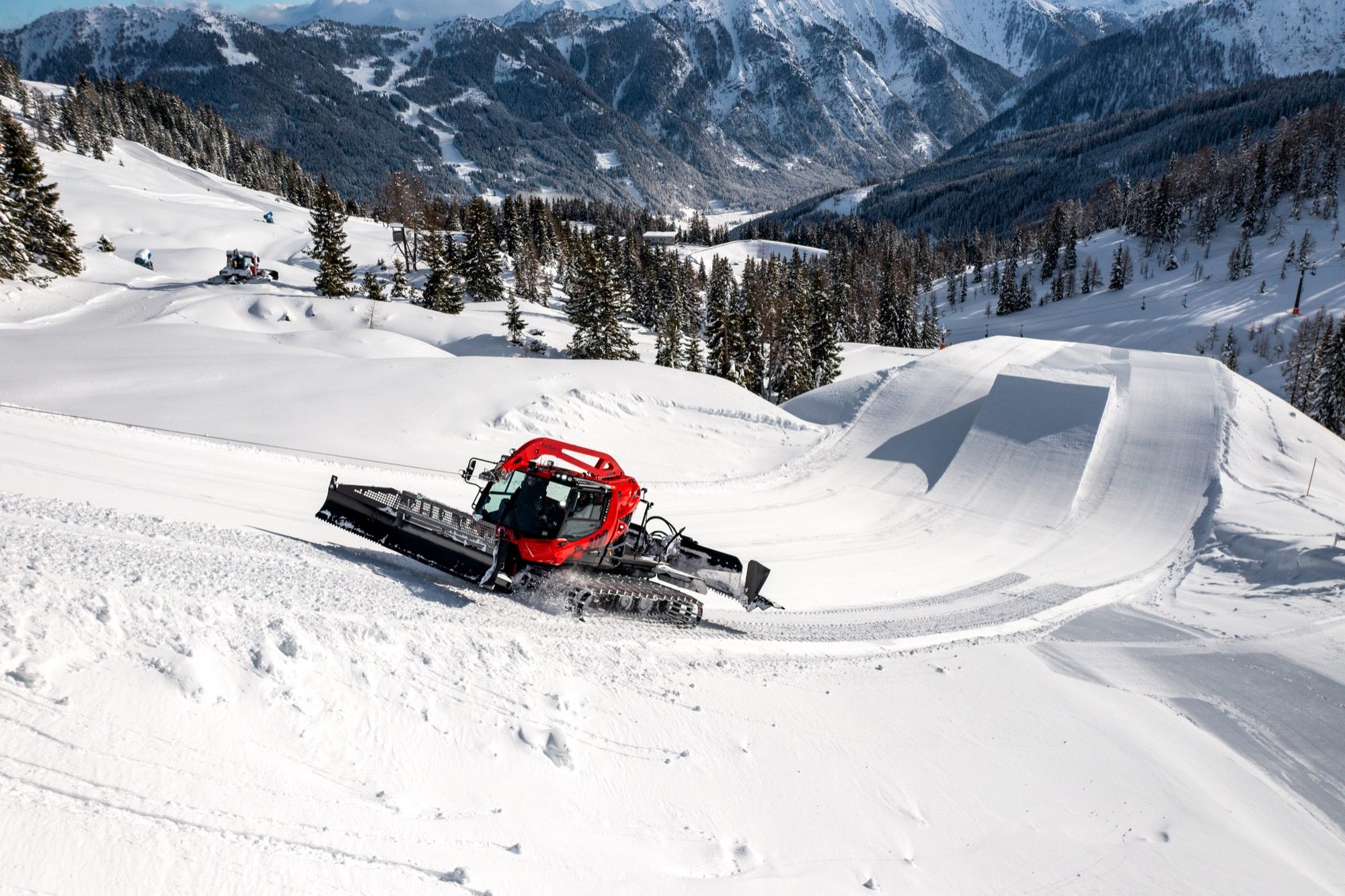PistenBully 400 shaping a terrain park feature