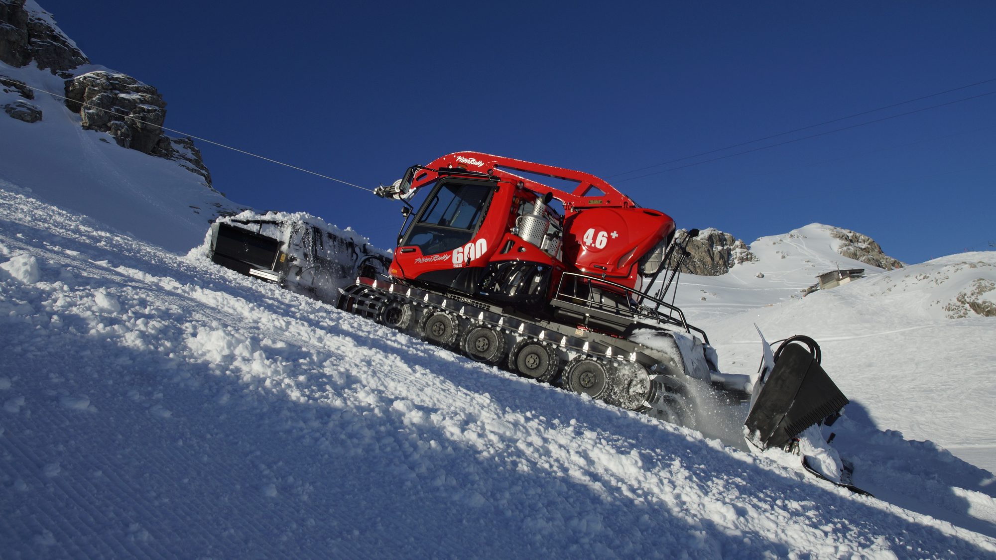 PistenBully 600 W winch edition on a steep alpine face